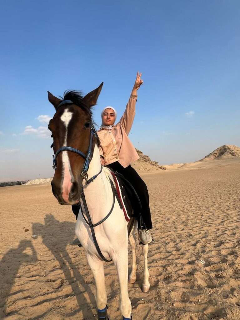 Rider waving on horseback in the Saqqara desert