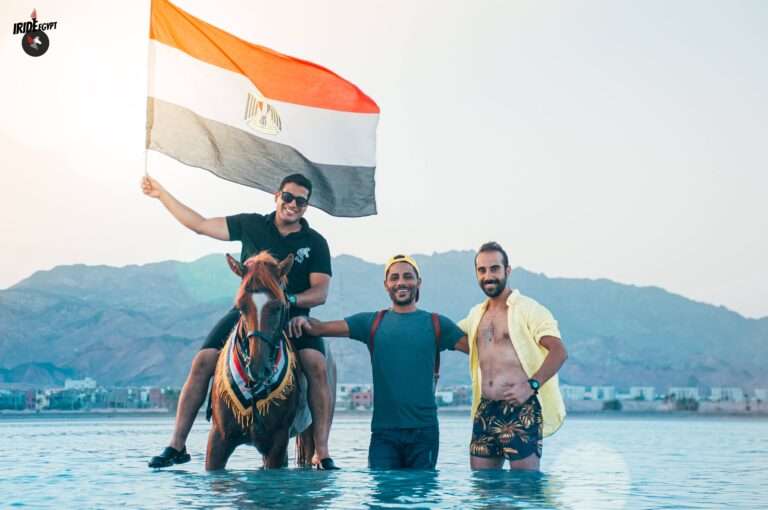 Riders with the Egyptian flag in the sea at Dahab