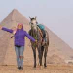 Guest with a grey horse in front of the Pyramids of Giza