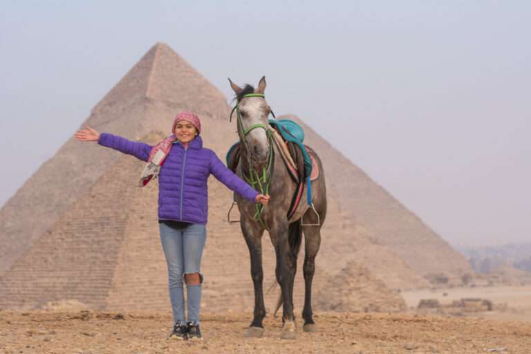 Guest with a grey horse in front of the Pyramids of Giza
