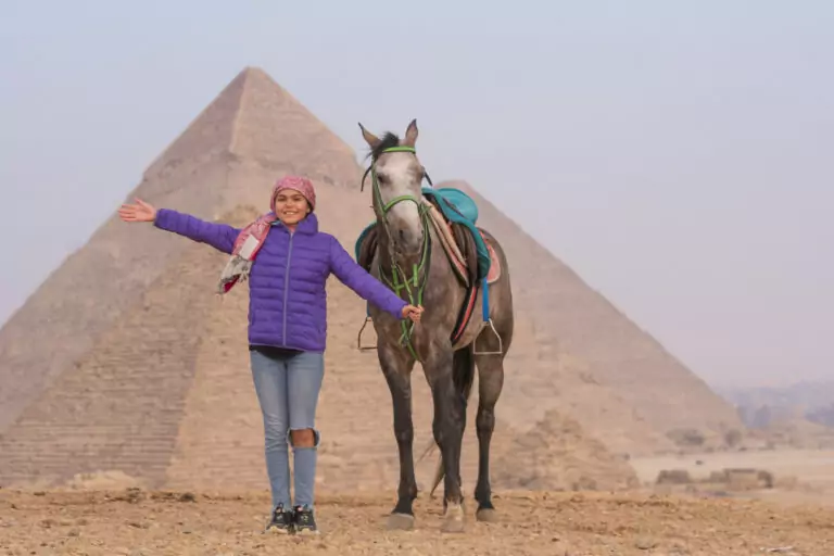 Guest with a grey horse in front of the Pyramids of Giza