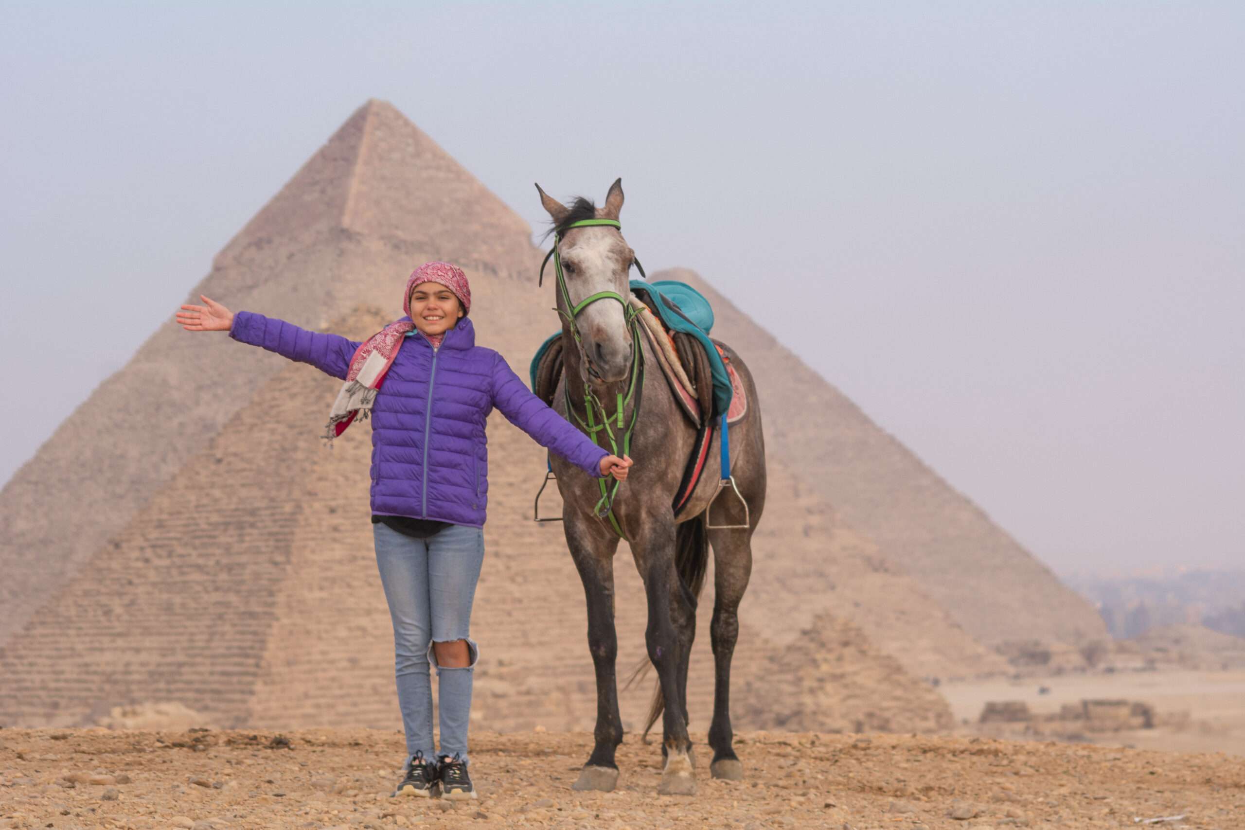 Guest with a grey horse in front of the Pyramids of Giza