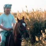 Rider on a chestnut horse among the reeds of Fayoum