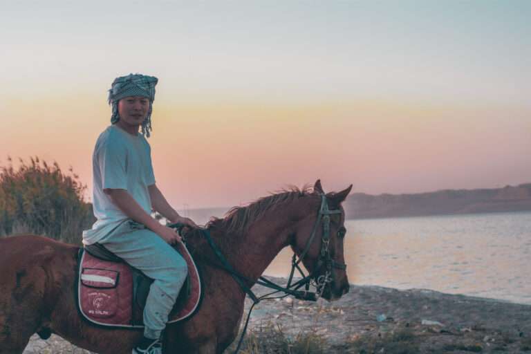 Sunset horse ride on the shore of Lake Qarun